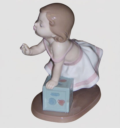 "My First Step" Lladro Figurine #6428 - Baby Girl with Block (6")