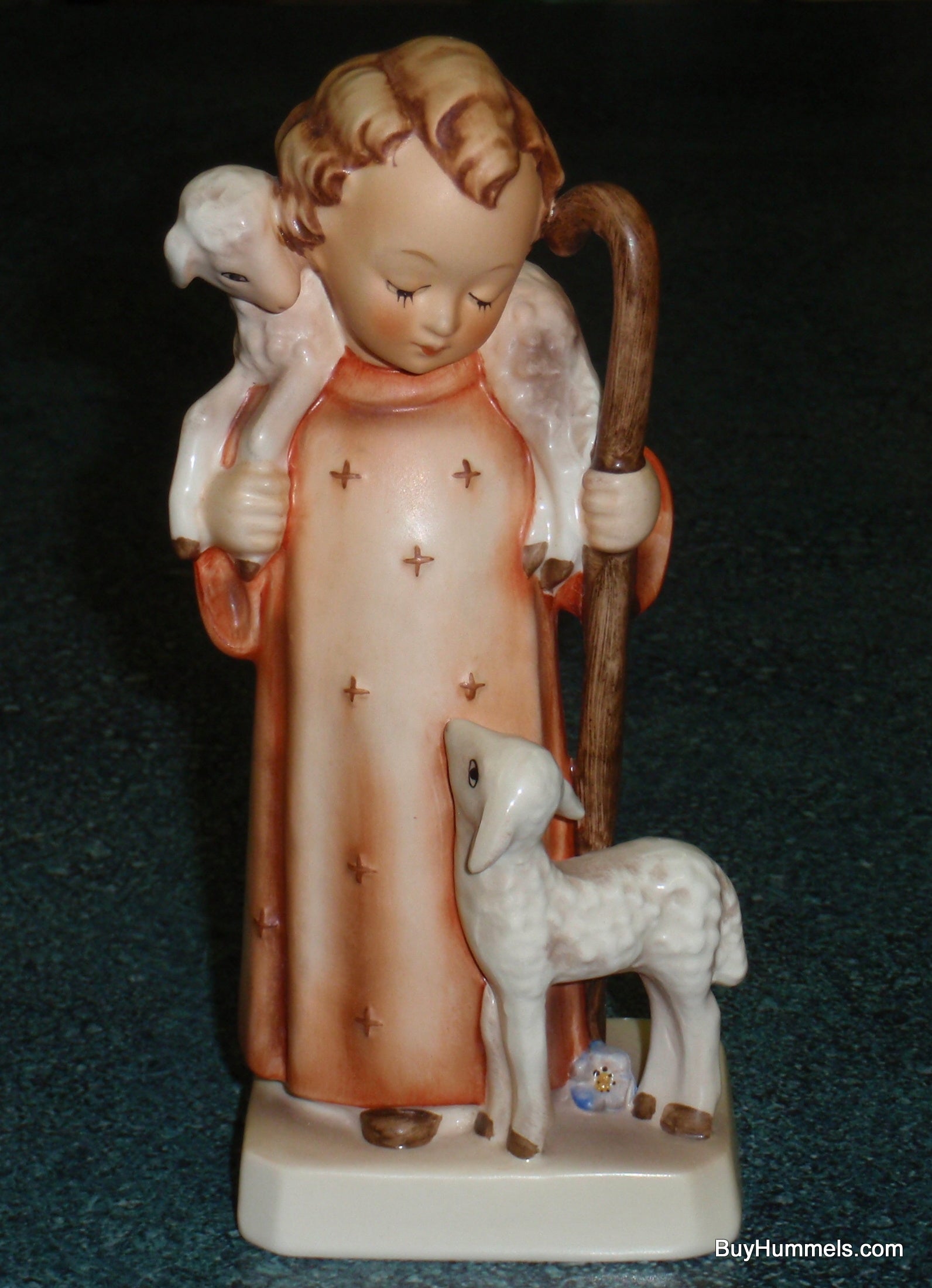 Front view of Goebel Hummel Good Shepherd figurine #42/0 featuring a boy with two lambs.