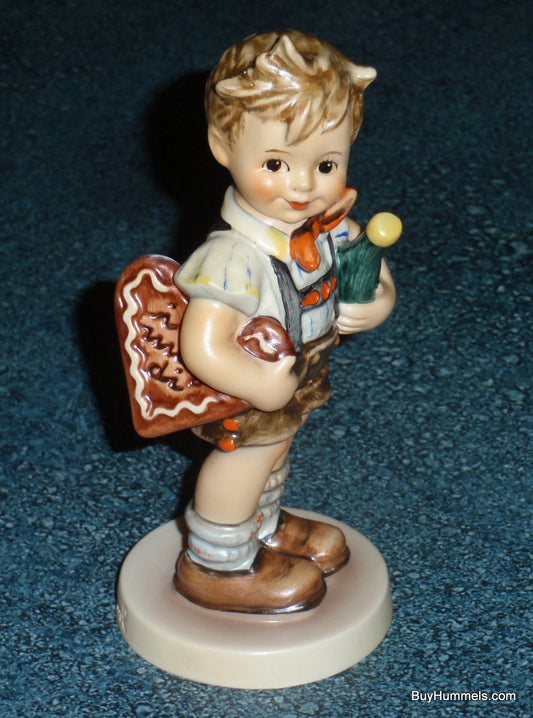 Close-up of the "Valentine" heart and vibrant hand-painted details on Hummel #399