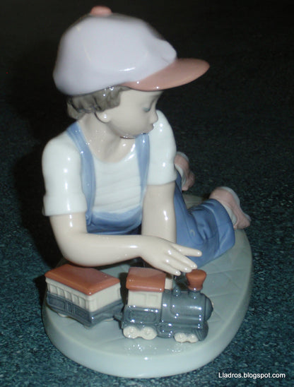 "All Aboard" Lladro Little Boy With Train Figurine #7619