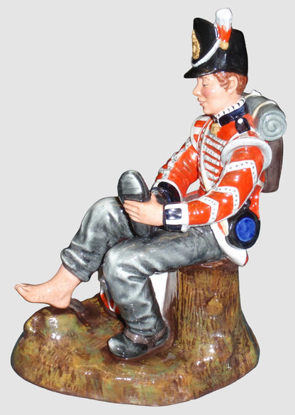Front view of Royal Doulton Drummer Boy figurine HN2679 sitting with a drum